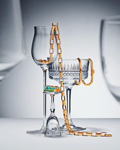 two wine glasses with chains attached to them