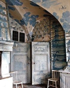 an old fashioned kitchen with blue and white paint on the walls