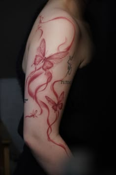 a woman's arm with red ink on it and butterflies around the arm area