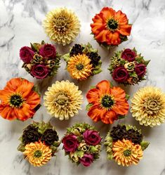 an arrangement of flowers arranged on a marble surface