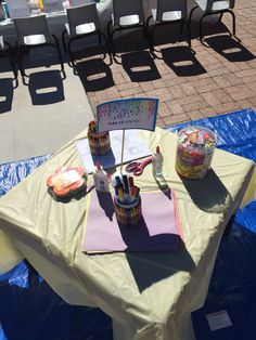 the table is set up for an outdoor birthday party