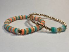 Teal, turquoise, gold, orange, peach, white, gold star, blue, yellow, mustard yellow, bracelet is 17 cm around, beach, boho, clay bead, gold plastic beads, trendy, glued knot, secure end Orange Heishi Beads Bracelets For Beach, Casual Gold Stretch Bracelet For Beach, Bohemian Gold Stretch Bracelet For Beach, Gold Stretch Bracelet With Colorful Beads For Beach, Bohemian Orange Stretch Bracelet For The Beach, Bohemian Orange Stretch Bracelet For Beach, Multicolor Bracelets With Gold Beads For Beach, Multicolor Friendship Bracelets With Gold Beads For Beach, Casual Beaded Bracelet With Gold Beads For Beach