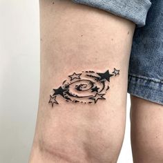 a woman's arm with stars and a circle tattoo on it