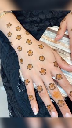 a woman's hands with tattoos on them