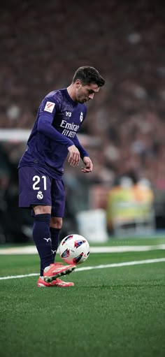 the soccer player is getting ready to kick the ball