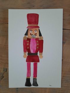 a watercolor drawing of a nutcracker wearing a top hat and red pants