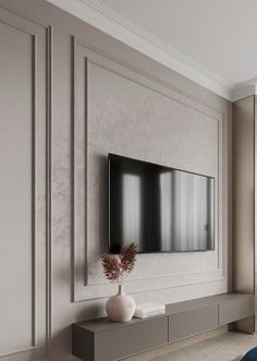 a large flat screen tv mounted to the side of a wall in a living room