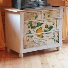 an old dresser with fruit and vegetables painted on the drawers is shown in front of a window