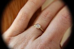 "This flash rainbow moonstone ring has a subtle, lux feel to it. I have set this 5mm round smooth rainbow moonstone gemstone into a solid 14kt yellow bezel cup with a thicker band ring. The 16 gauge solid 14kt yellow band has been also highly polished for a very reflective shine. This listing is for 1, 5mm rainbow moonstone ring. Material Information: Clarity: Occlusioned Color: rainbow Gemstone: moonstone Metal: 14kt yellow gold Handcrafted band: 16 gauge (1.4mm) faceted Please contact me with Gemstone Stacking Ring, Ring Moonstone, Rainbow Gemstones, Rainbow Moonstone Ring, June Birthstone, Moonstone Ring, Ring Engagement, June Birth Stone, Stacking Ring