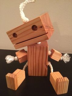 a wooden toy with ropes attached to it