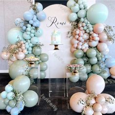 balloons and cake are arranged in the shape of an arch