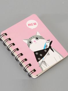 a pink notebook with a cat drawn on the front cover and mew speech bubble above it