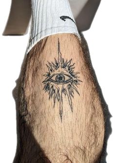 a man's leg with an all seeing eye tattoo on it