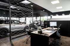 a car showroom with cars parked in the background