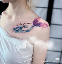 a woman with a tattoo on her chest has an ocean wave in the shape of a fish