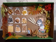 a cardboard box filled with different types of food and decorations on top of a wooden table