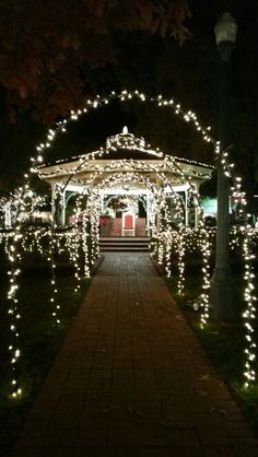 a gazebo covered in christmas lights at night