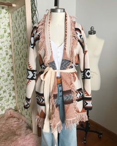 A stunning knit blanket sweater that is perfectly cozy for the season. Open front & soft fringe fold over collar. Color: Cream, camel & black Poly Hand wash cold Model is a size 8 wearing a medium. Small Medium Large Bust 50 52 53 Waist 49 51 52 Hips 51 53 54 Length 31 31 31 Bust, waist, and hip measurements are a total circumference. Length is measured from the top of the shirt to the hem. Measurements are an estimate. Cozy Fringe Outerwear For Fall, Fall Outerwear With Tassels, Cozy Long Sleeve Outerwear With Fringe, Beige Fringed Winter Outerwear, One Size Fringe Sweater For Fall, Cozy Shawl Collar Sweater For Fall, Cozy Fringe Cardigan For Fall, Chic Fringe Sweater For Fall, Bohemian Fringe Outerwear For Fall