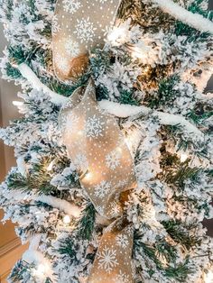 a white christmas tree with gold and silver ornaments