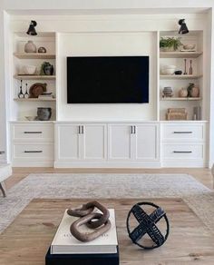 a living room filled with furniture and a flat screen tv mounted to the side of a wall