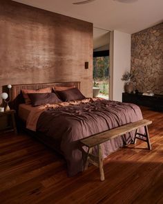 a large bed sitting on top of a wooden floor