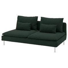 a green couch with two pillows on it and one pillow is folded over the back