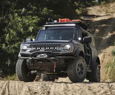 an off - road vehicle driving down a dirt road