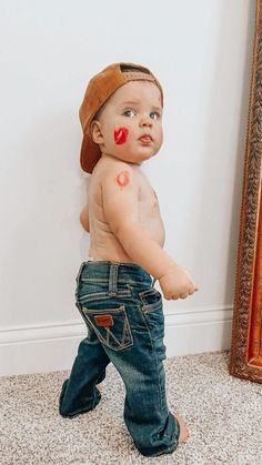 a small child with red paint on his face