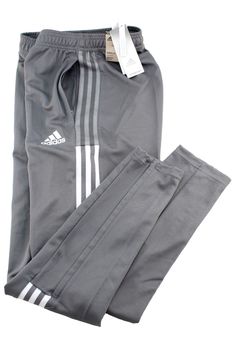 New With Tags ADIDAS  Tiro Track Zip Men's Size 4XL  Team Grey with White Stripes 2 Zippered Front Pockets 12 inch Leg Zipper  Stretch Waist with Drawstring  Jogger Pants INSEAM: 33 INCHES     MAJOR BRANDS DISCOUNT PRICE  $37.99 FREE SHIPPING PRODUCT FEATURES: ADIDAS Tiro Track Zip 12" Leg Zip Jogger Pants Front Style: Flat Front Features: Elastic Waist Leg Zipper: 12 inches Front Style: Flat Front Closure Type: Drawstring Fit: Regular Tapered Fit Pockets: 2 Side Zippered Slip Pockets Regular Tapered Fit is Comfortable and Roomy Yet Narrow at the Ankle Rise: At Waist Fabric Content: 100% Polyester These Pants are Made with Recycled Polyester to Save Resources Fabric Description: Synthetic Inseam: 33 Inches Care: Machine Wash, Tumble Dry Country of Origin: Phillipines PLEASE CONTACT US WITH Men Jogger Pants, Men Jogger, Mens Jogger Pants, Adidas Sweatpants, Drawstring Jogger, Active Wear Pants, Adidas Pants, Discount Price, Mens Activewear