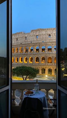 an open window with a view of the roman colossion