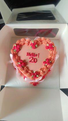 a heart shaped cake in a box with the number 20 on it's side