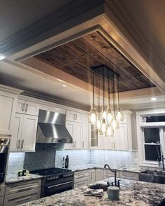 a kitchen with marble counter tops and an island in front of a stove top oven