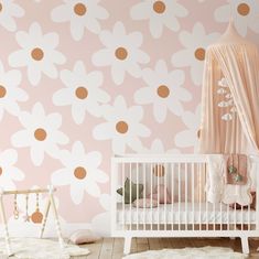 a baby's room with pink and gold wallpaper