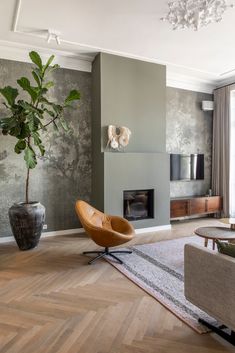 a living room filled with furniture and a fire place next to a wall mounted tv