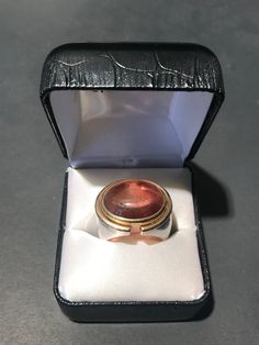 Beautiful custom made Pink Champagne Tourmaline Stone, with 18k gold and sterling silver ring. Very substantial one of one piece- a show stopper. We purchased this piece as part of a jewelry collection in London, UK. Origin: London, UK Period: 1970 - 1979 Condition: Good, not brand new or in flawless condition- there is wear to the metals and stone. A choice piece. US Ring Size: US 8 * Complimentary shipping to Continental US. * Our Guarantee: Items purchased online will arrive as described. Unique Cabochon Ruby Ring For Formal Occasions, Luxury Polished Tourmaline Rings, Formal Heirloom Tourmaline Jewelry, Polished Tourmaline Ring As Gift, Polished Tourmaline Rings For Gift, Formal Hallmarked Tourmaline Jewelry, Silver Tourmaline Rings For Formal Occasions, One Of One, Tourmaline Stone