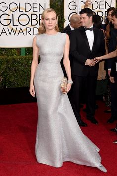 the actress in a silver gown at the golden awards red carpet, with her hand on her purse