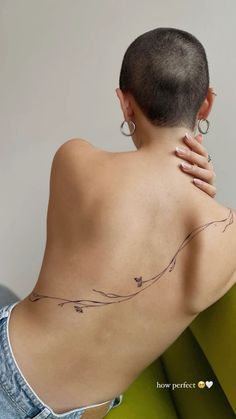 a woman with a tattoo on her back