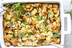 a casserole dish filled with stuffing and vegetables