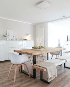 a dining room table with two chairs and a bench