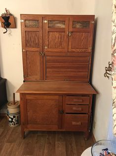 a wooden cabinet sitting on top of a hard wood floor