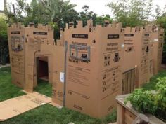 a cardboard castle made to look like it is in the grass