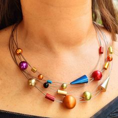 If you're on the hunt for a fashionable statement piece, we've got just the thing for you. Our handmade multicolored bib necklace is sure to catch the eye with its bold and elegant design. Made of anodized aluminum beads in various shapes, this necklace is both practical and comfortable to wear thanks to its adjustable silver chain. Perfect for any woman who appreciates unique style, this versatile necklace complements a variety of looks. Make a statement and stand out with this one-of-a-kind je Multicolor Beaded Necklace For Party, Multicolor Metal Beaded Necklaces For Party, Colorful Metal Necklaces For Gifts, Colorful Metal Necklaces As Gift, Colorful Metal Necklace As A Gift, Multicolor Metal Necklaces With Unique Variations, Trendy Multicolor Necklace With Chunky Chain, Multicolor Multi-strand Necklace For Party, Multi-strand Chunky Chain Necklace As A Gift