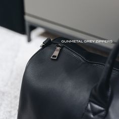 Designed to be minimal and understated, we've made a bag perfect for everyday use. It has an outer zip pocket, a grab handle, three inside pockets, and a leather shoulder strap. 52cm x 22cm (can be used as carry-on luggage) Includes shoulder strap Outer zip pocket perfect for accessories Two open inside pockets and one inside zipped pocket Made from vegan leather. Everyday Leather Travel Bag With Zipper, Modern Soft Leather Duffle Bag For Daily Use, Leather Duffle Bag With Zipper For On-the-go, Leather Duffle Bag With Zipper Closure For On-the-go, Modern Weekender Bag For Business Trips, Modern Weekender Bag With Zipper For Business Trips, Modern Travel Bag With Zipper For Everyday Use, Modern Travel Bag With Zipper Closure For Everyday Use, Modern Gym Bag With Zipper Pocket For Everyday Use