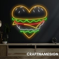 a neon heart - shaped burger is shown on the wall