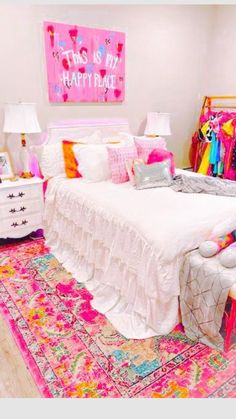 a room with a bed, dresser and colorful rug