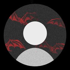 a black and white circular with red bats on the side, in front of a dark background