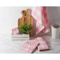 towels, potted plant and cutting board on counter