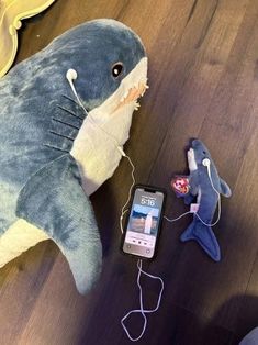 a stuffed shark is next to an mp3 player