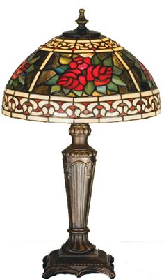 a stained glass lamp sitting on top of a wooden table