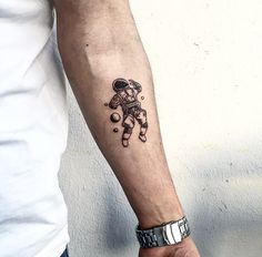 a man with a small tattoo on his arm